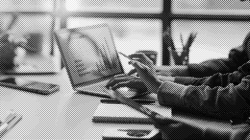 People analyze graphs on a laptop in a meeting room with natural light.