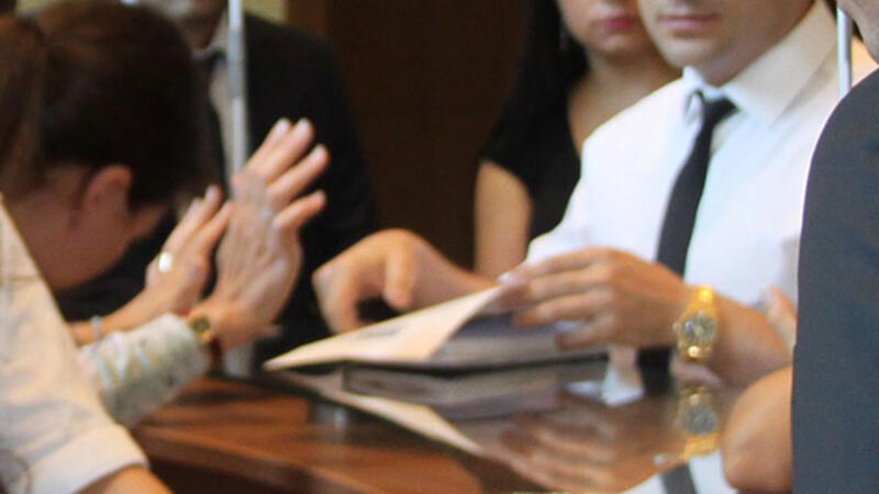 Business meeting with people discussing and reviewing documents at a table.